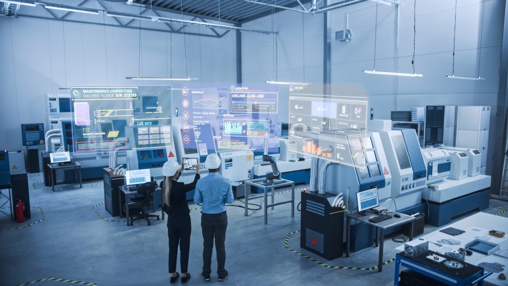 Man and woman using a tablet to envision manufacturing processes, Man and woman using digital solutions at work in manufacturing environment
