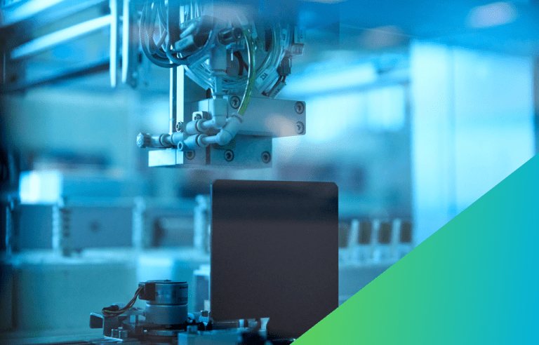 A close-up of high-tech automated equipment in a clean factory environment.