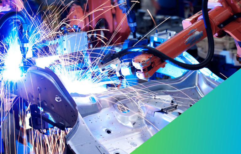 A robotic welding arm is shown generating bright sparks as it performs a weld on a metal car body component on an automated production line.