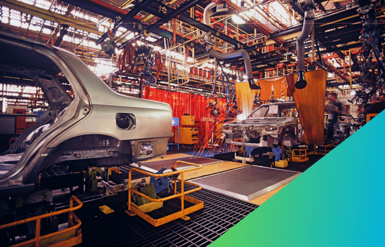 An automobile assembly line is shown with two car bodies in different stages of production, surrounded by welding machinery and industrial equipment.