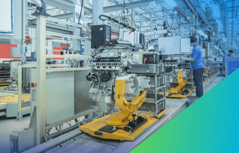 Engines on yellow automated guided vehicle carriers move along an assembly line in an automotive factory, with workers visible in the background.