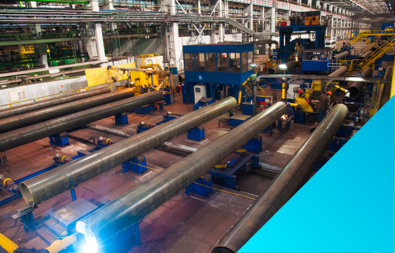 industrial manufacturing plant with large steel pipes.