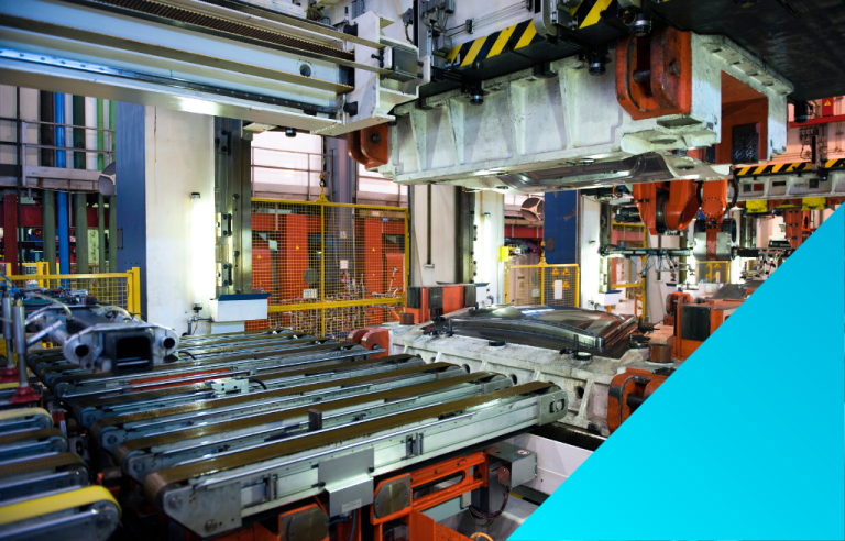 Heavy industrial machinery and conveyor belts in a factory, with a large hydraulic press visible overhead, and a car part is on the production line.